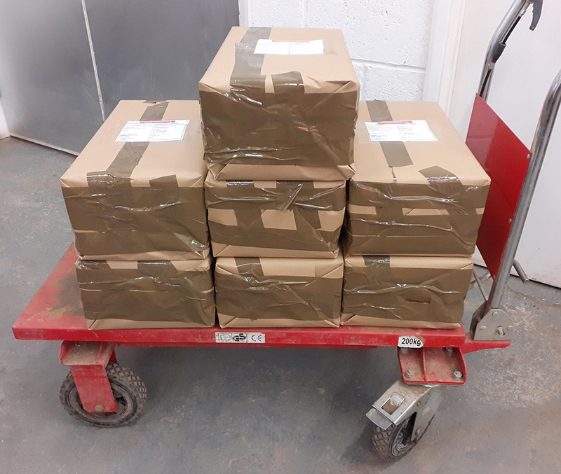 brown boxes on a trolley