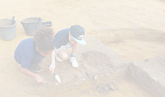 two children digging in a field